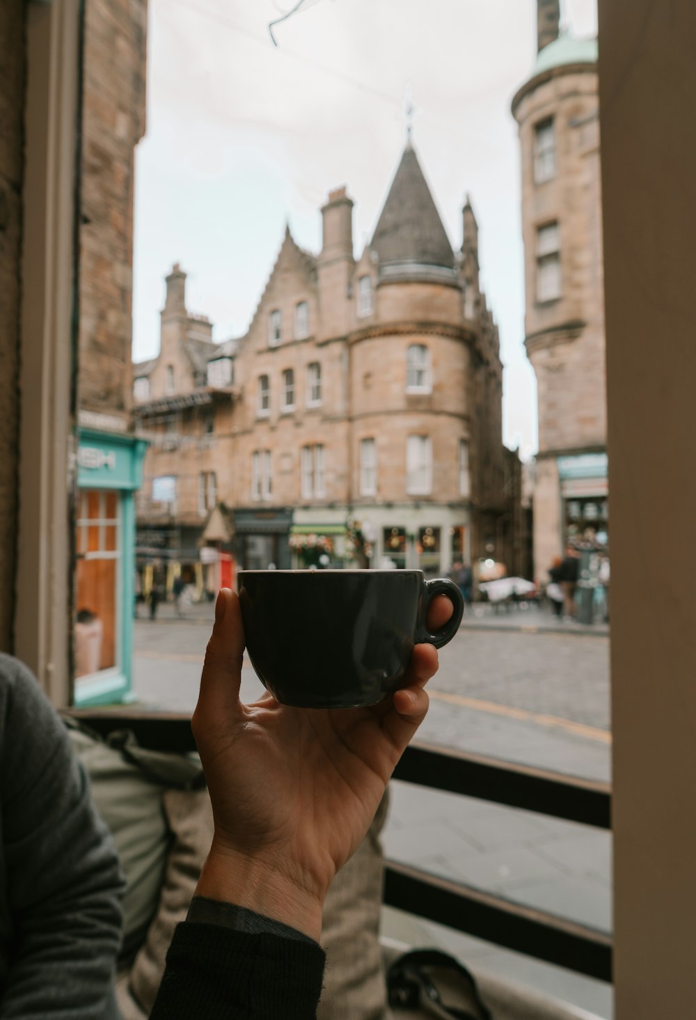 person holding black ceramic mug