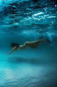 woman in blue bikini swimming in water