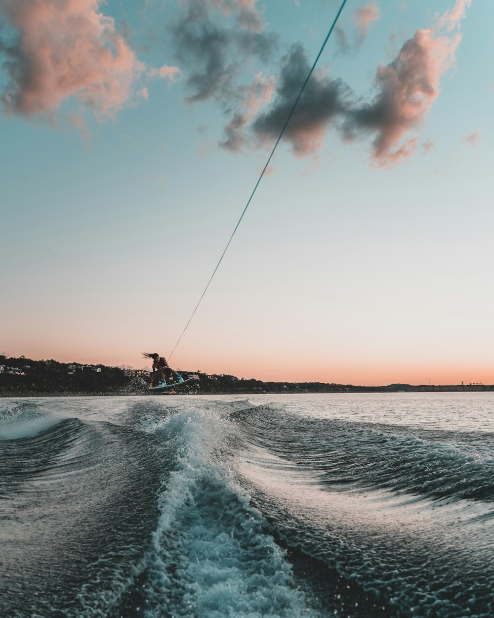 man surfing on sea waves during daytime