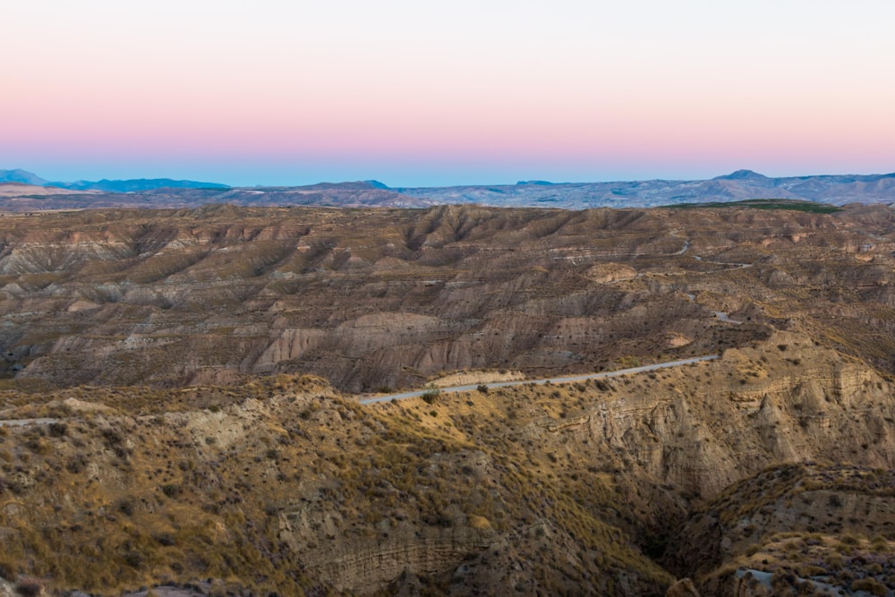 brown and green mountains under blue sky during daytime