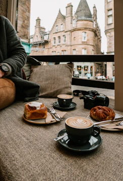 A cozy café scene captured in a social media post with latte art and pastries.