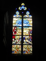 A stained-glass-like display blending holy symbols with cold, mechanical circuitry.