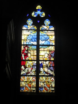 A stained-glass-like display blending holy symbols with cold, mechanical circuitry.