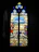 A stained glass window featuring religious imagery with vivid colors. The scene includes multiple human figures and a cross, set against a background with blue skies and clouds. The bottom section displays various heraldic symbols.
