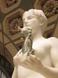 Close-up of intricate marble carving details on a spiritual sculpture