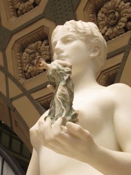 Close-up of intricate marble carving details on a spiritual sculpture