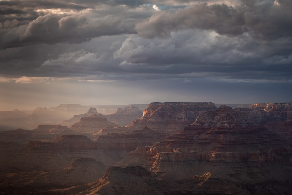 brown rocky mountain under cloudy sky during daytime