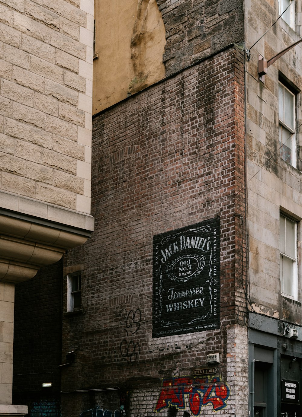 brown brick building with black and white signage