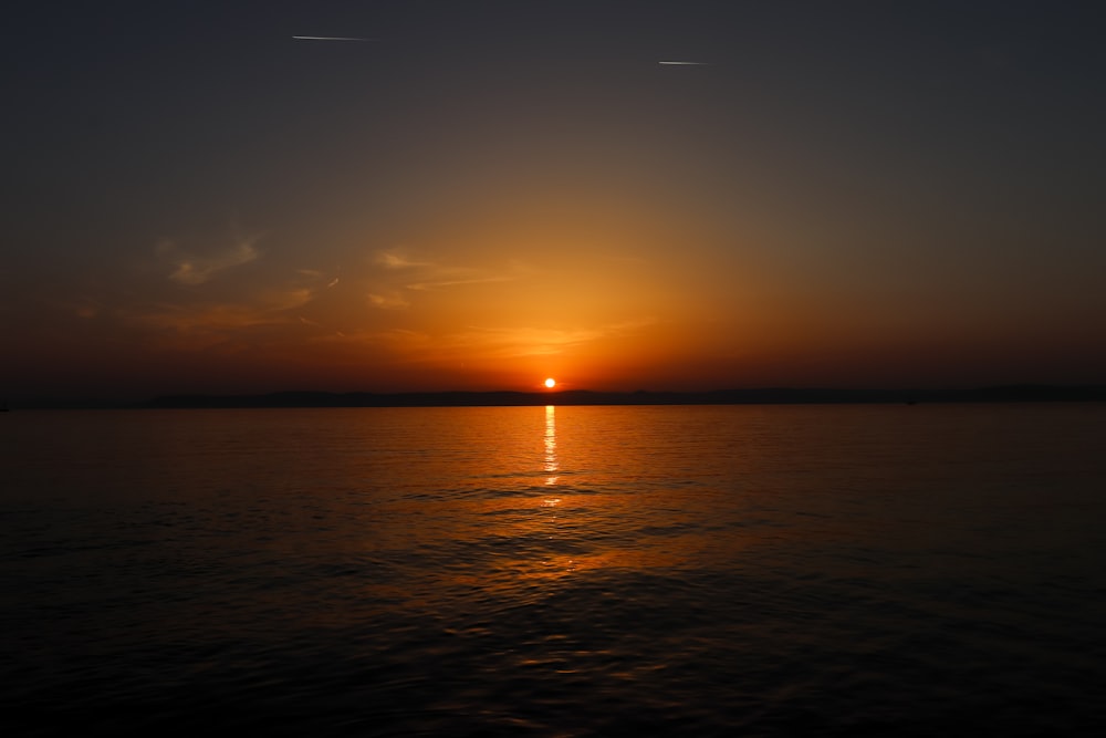 body of water during sunset