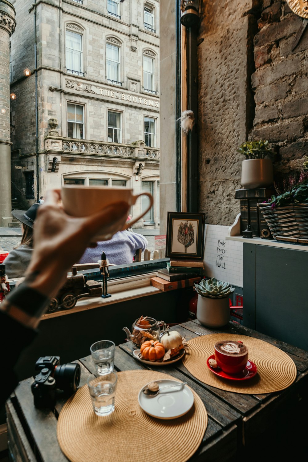 person pouring coffee on cup