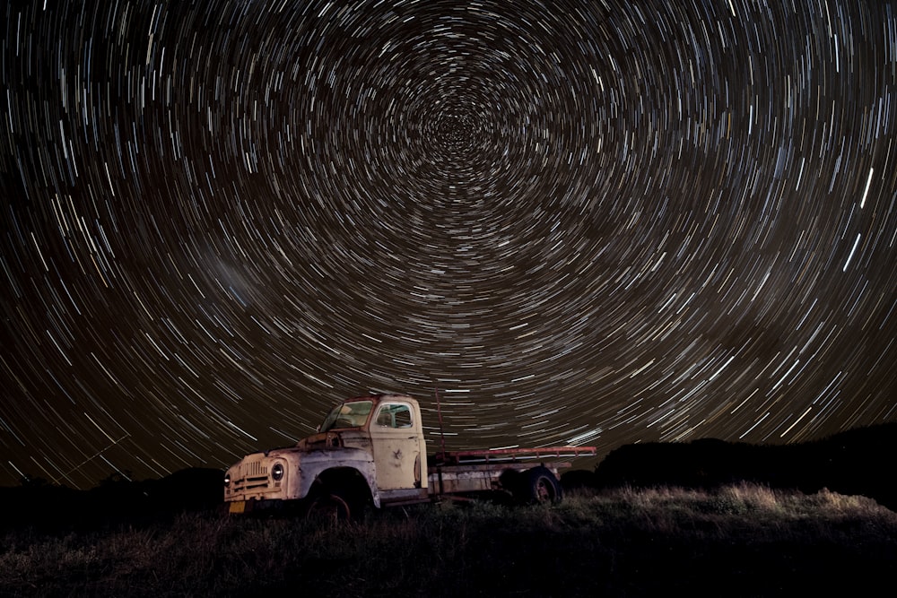 white truck with lights turned on during night time