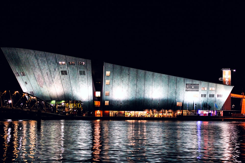 body of water near building during night time