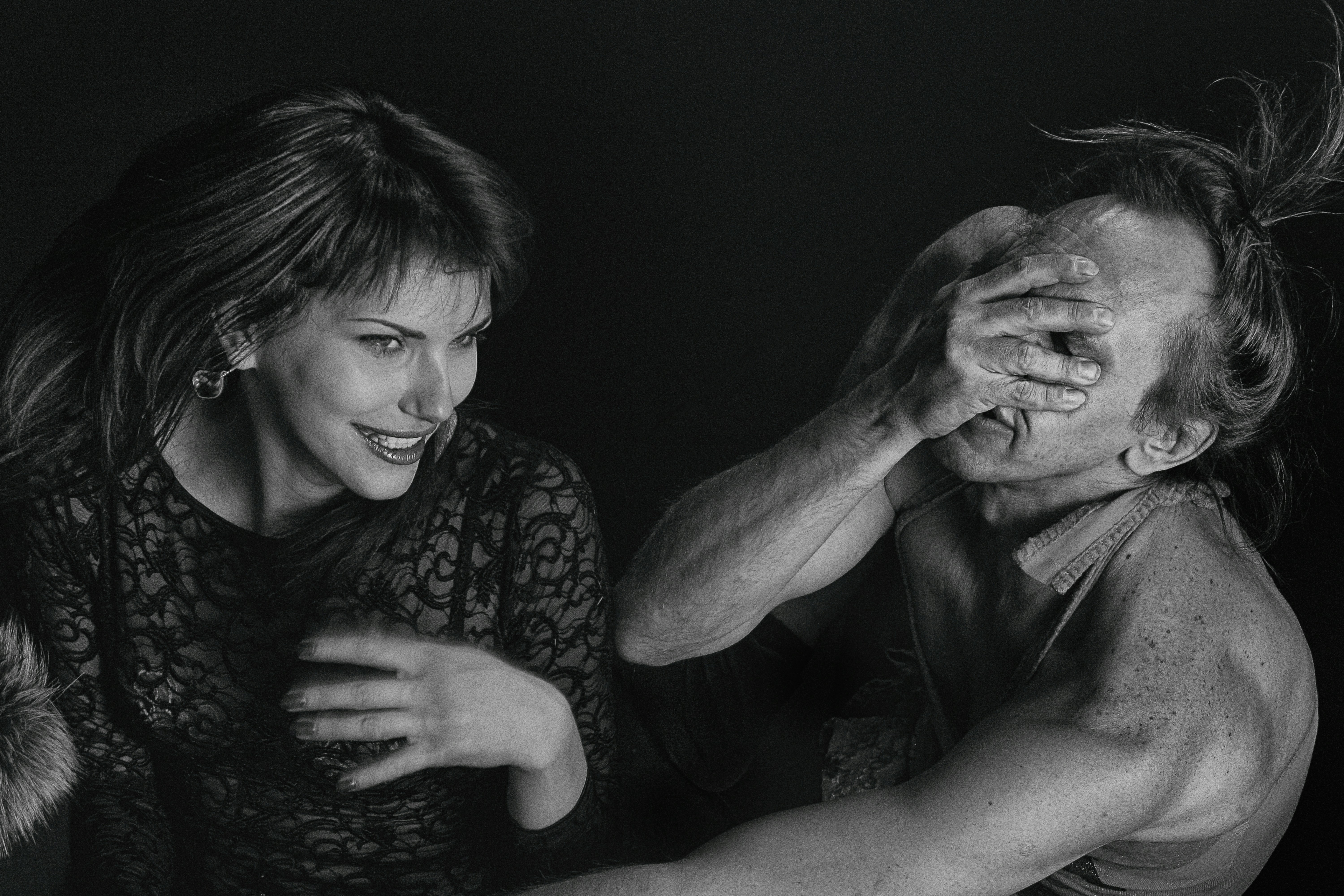 man and woman kissing on the cheek