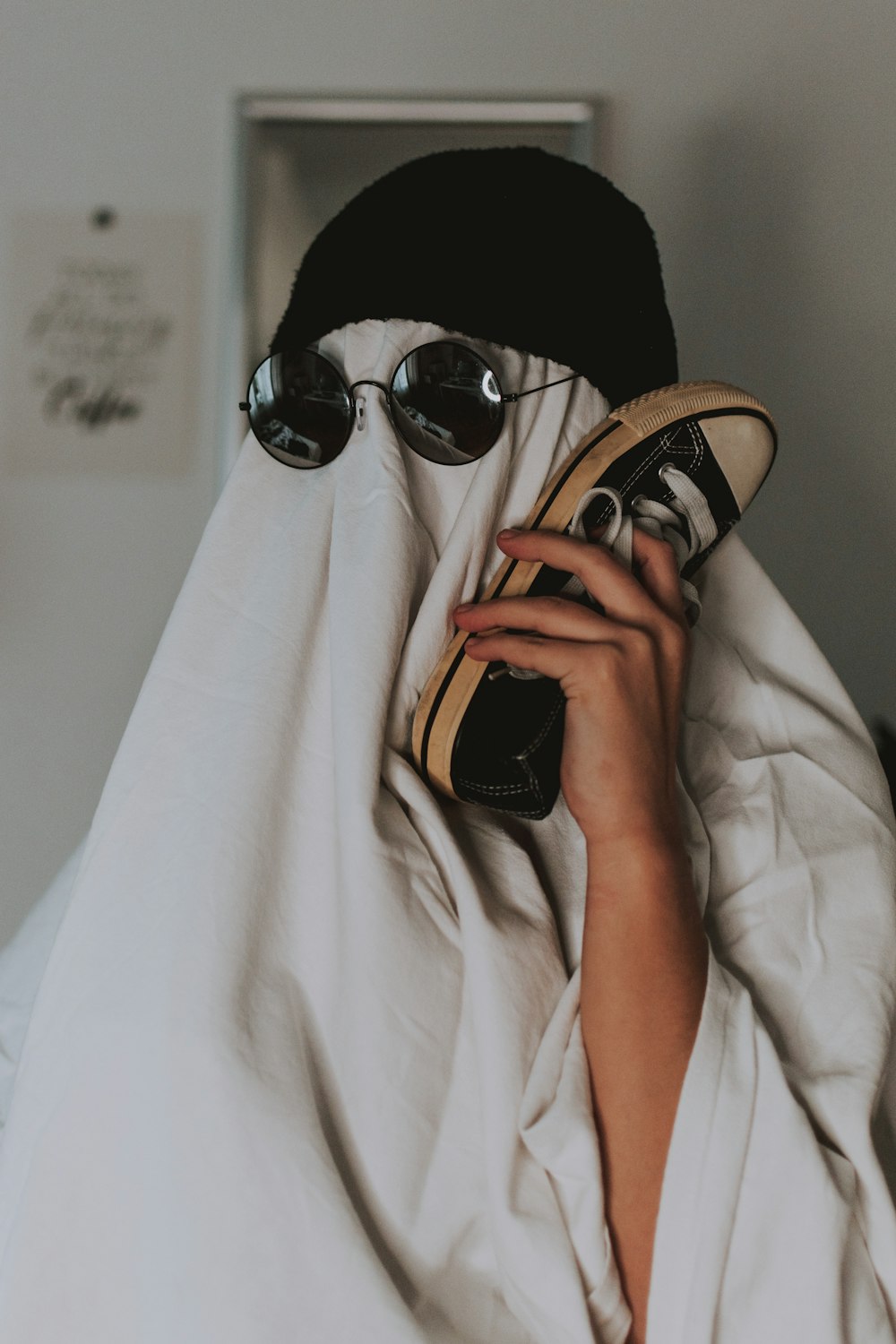 person in black hijab holding brown and black leather bag