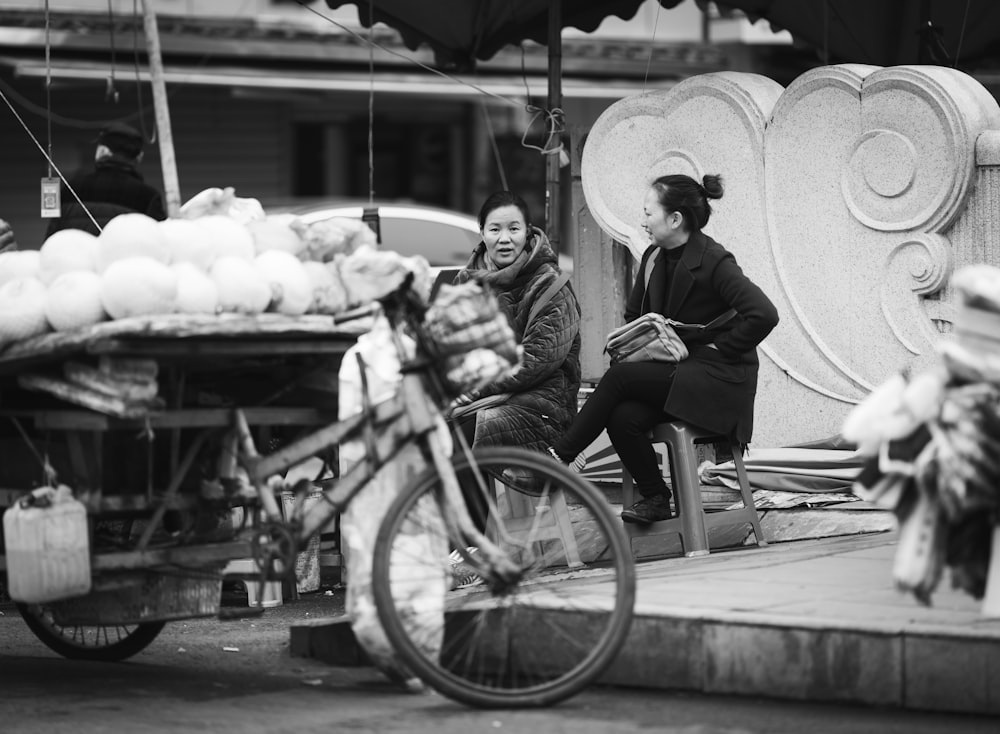 grayscale photo of woman sitting on wheelchair