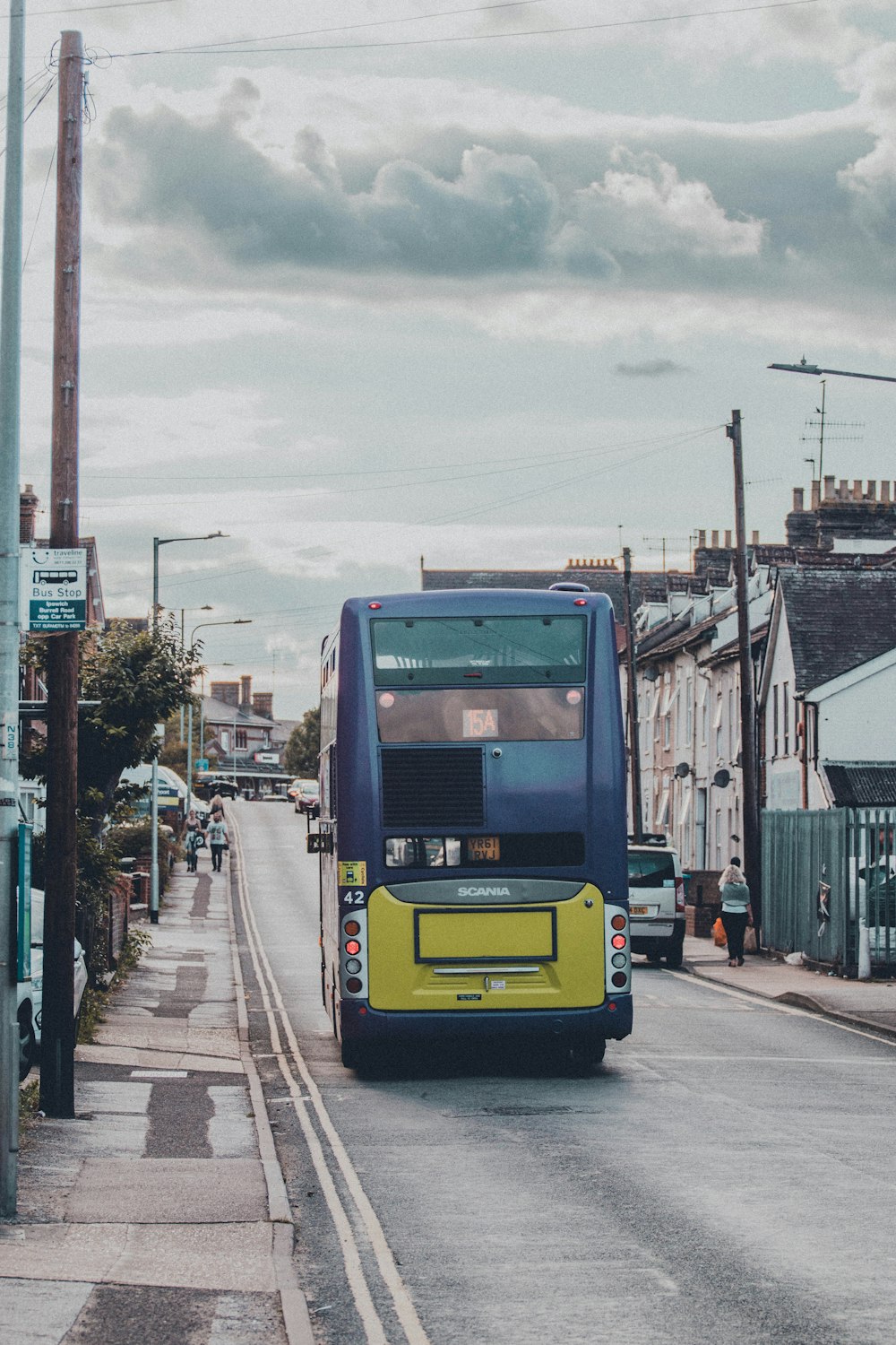 yellow and black bus on road during daytime