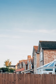 brown and white concrete houses under white sky during daytime