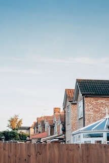 brown and white concrete houses under white sky during daytime