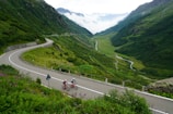 Cyclists racing intensely through a scenic mountain road
