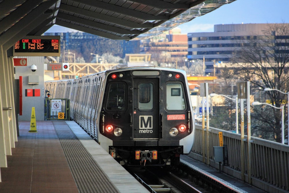 black and white train on rail during daytime