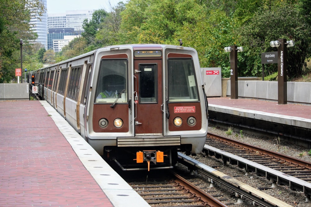 white and red train on rail tracks during daytime