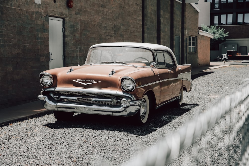 brown and white vintage car on snow covered ground