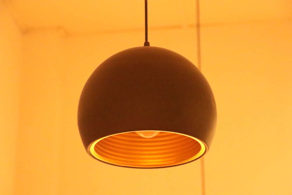 black pendant lamp turned on in room