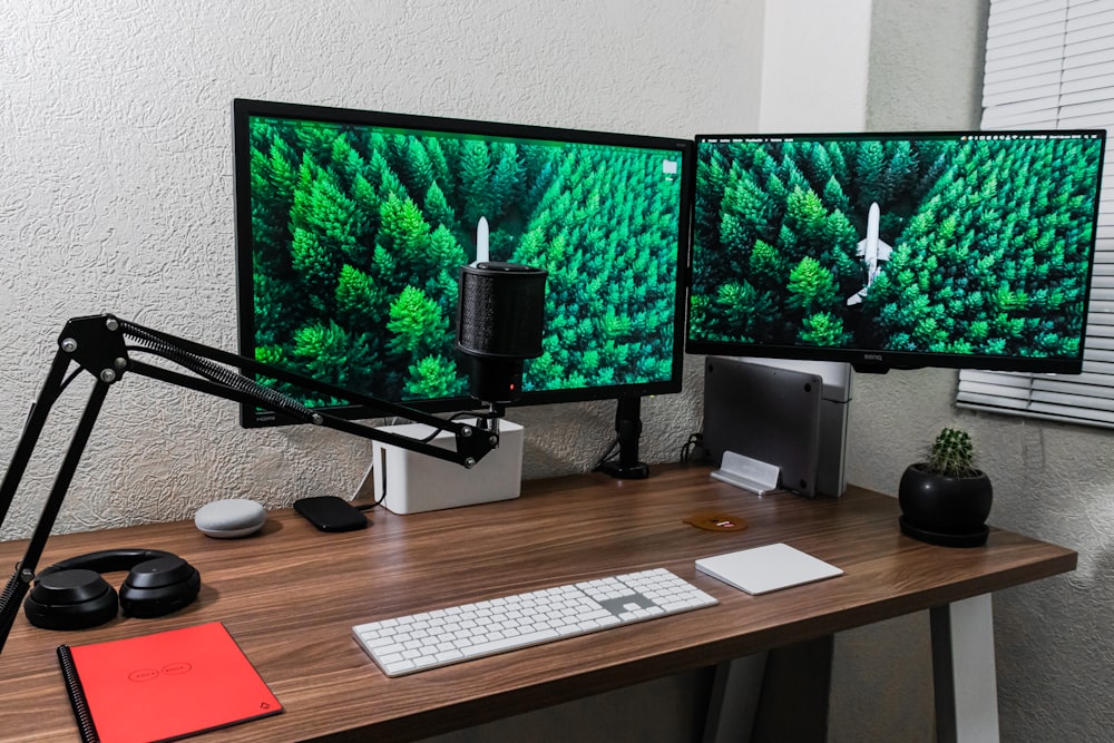 black flat screen computer monitor on brown wooden desk