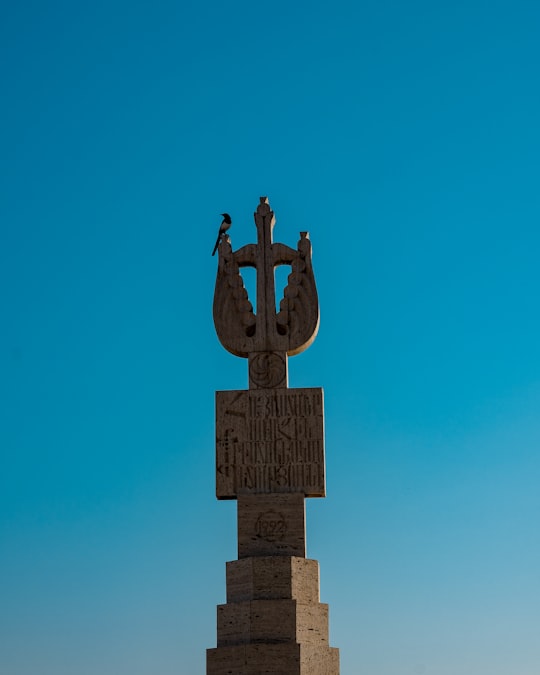 brown concrete cross with cross on top in Cafesjian Center for the Arts Armenia