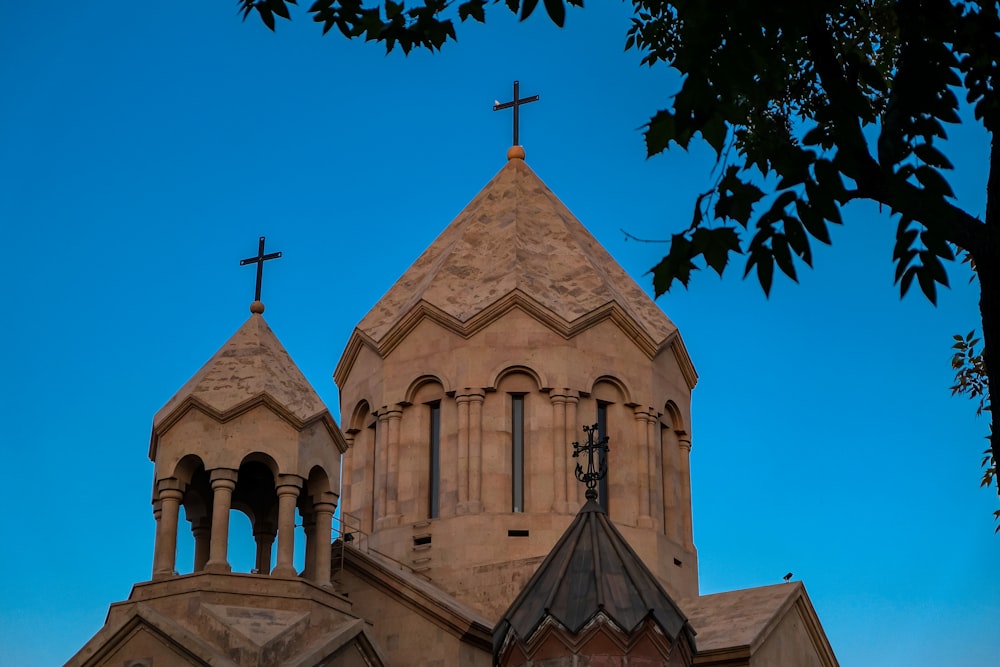 brown concrete church near green trees during daytime