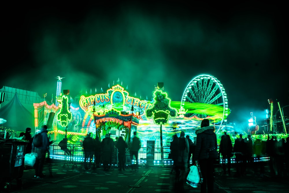 people walking on park with lights turned on during night time