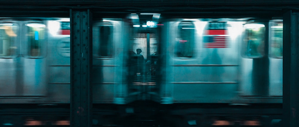 man in black jacket standing in front of white train