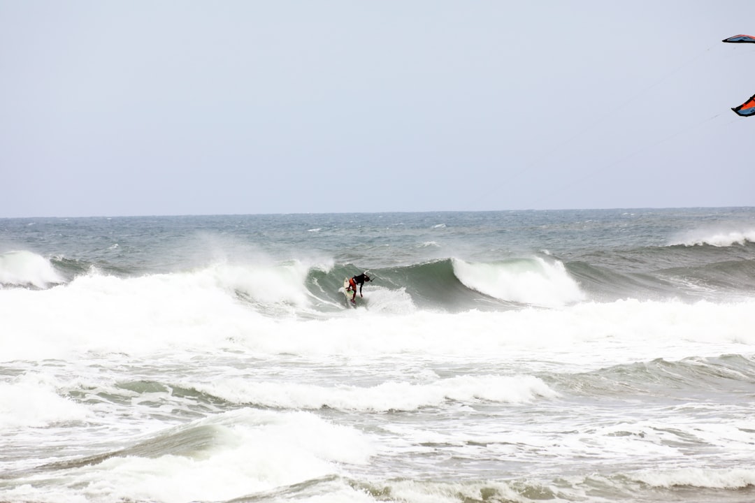 person surfing on sea waves during daytime