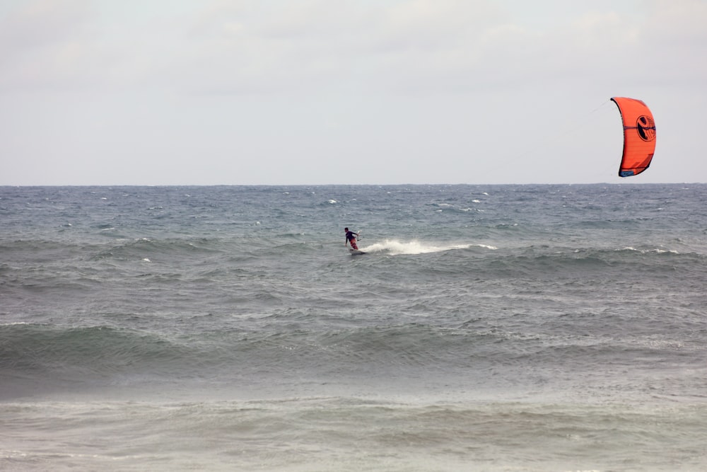 person surfing on sea waves during daytime