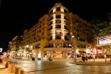 people walking on street near brown concrete building during night time