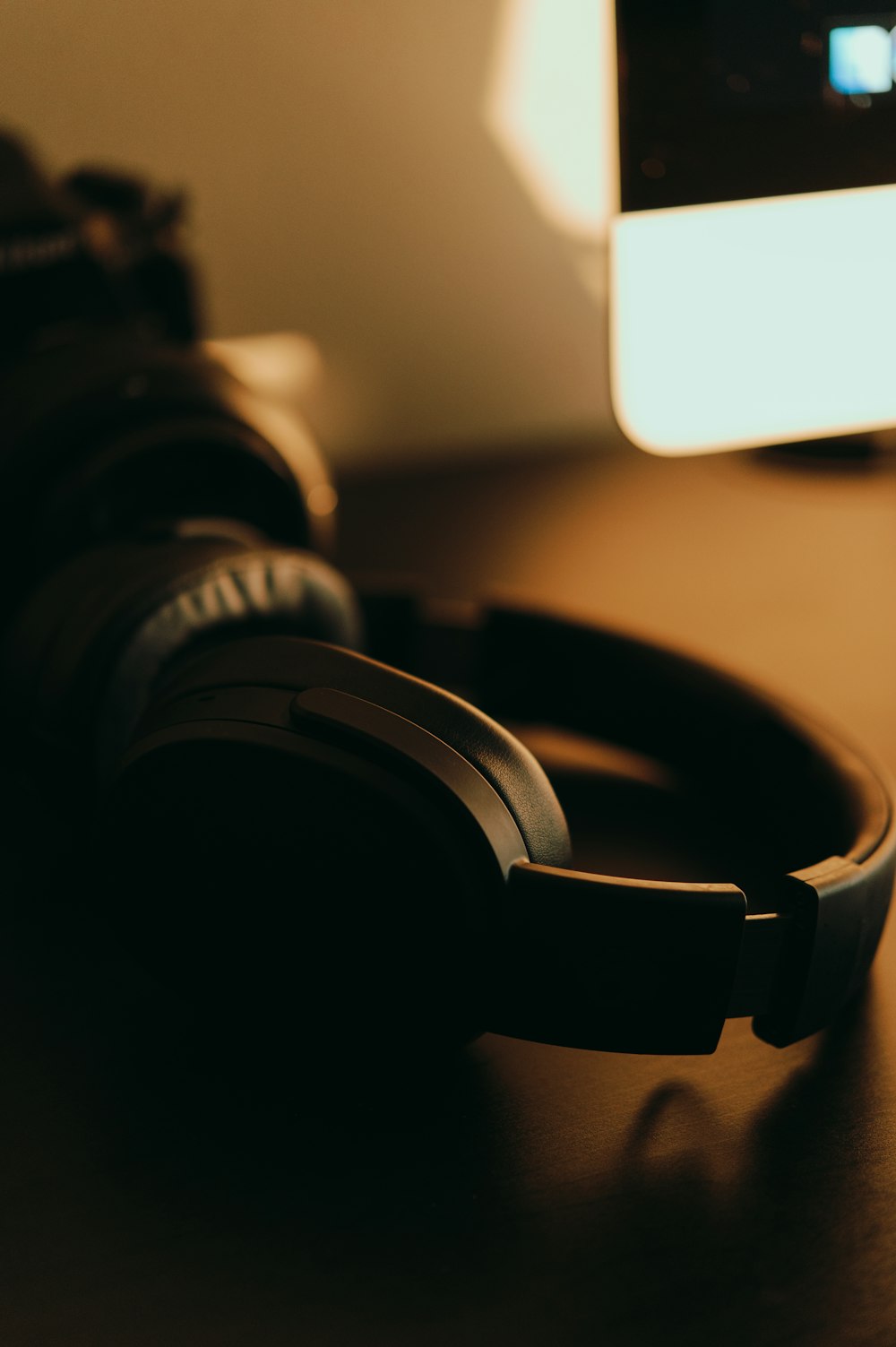 black and white headphones on brown wooden table