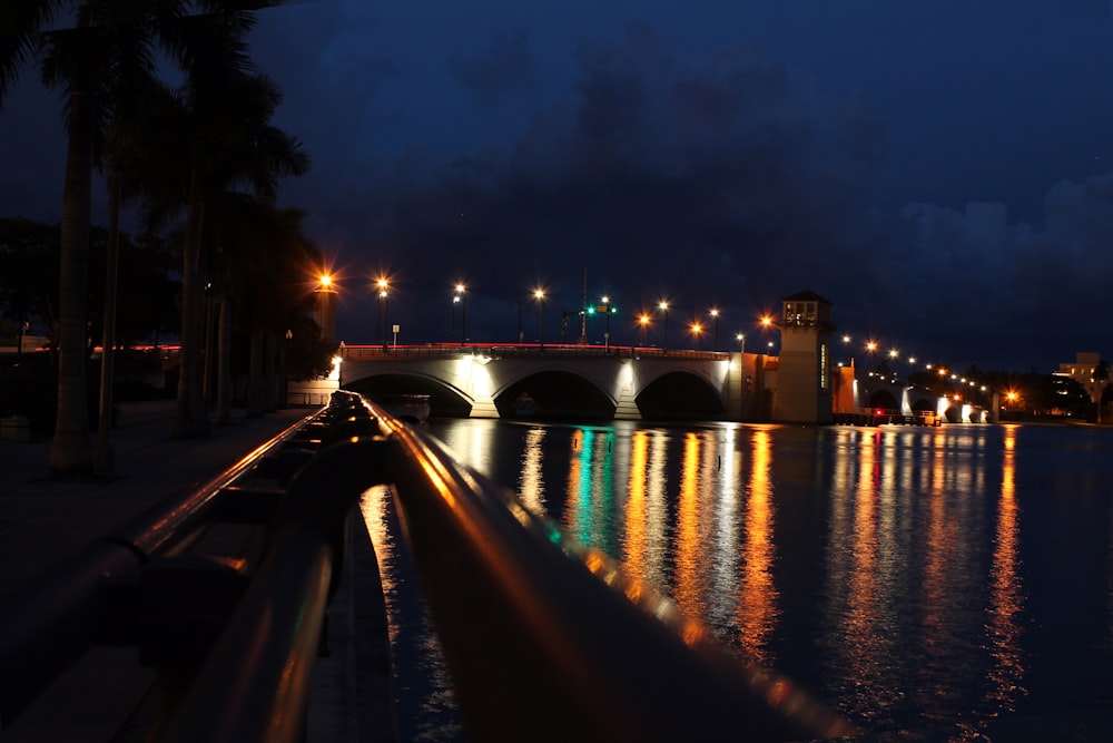 lighted bridge over river during night time