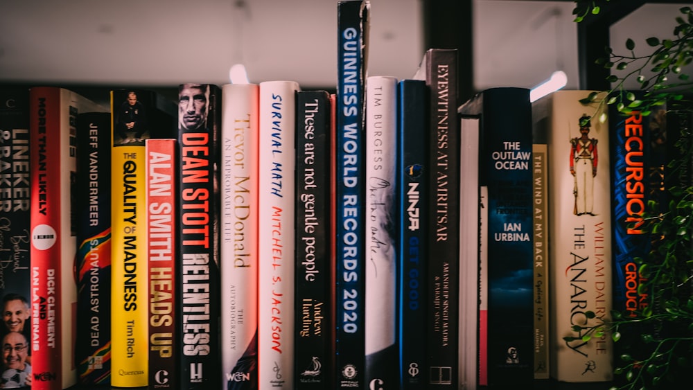 books on white wooden shelf