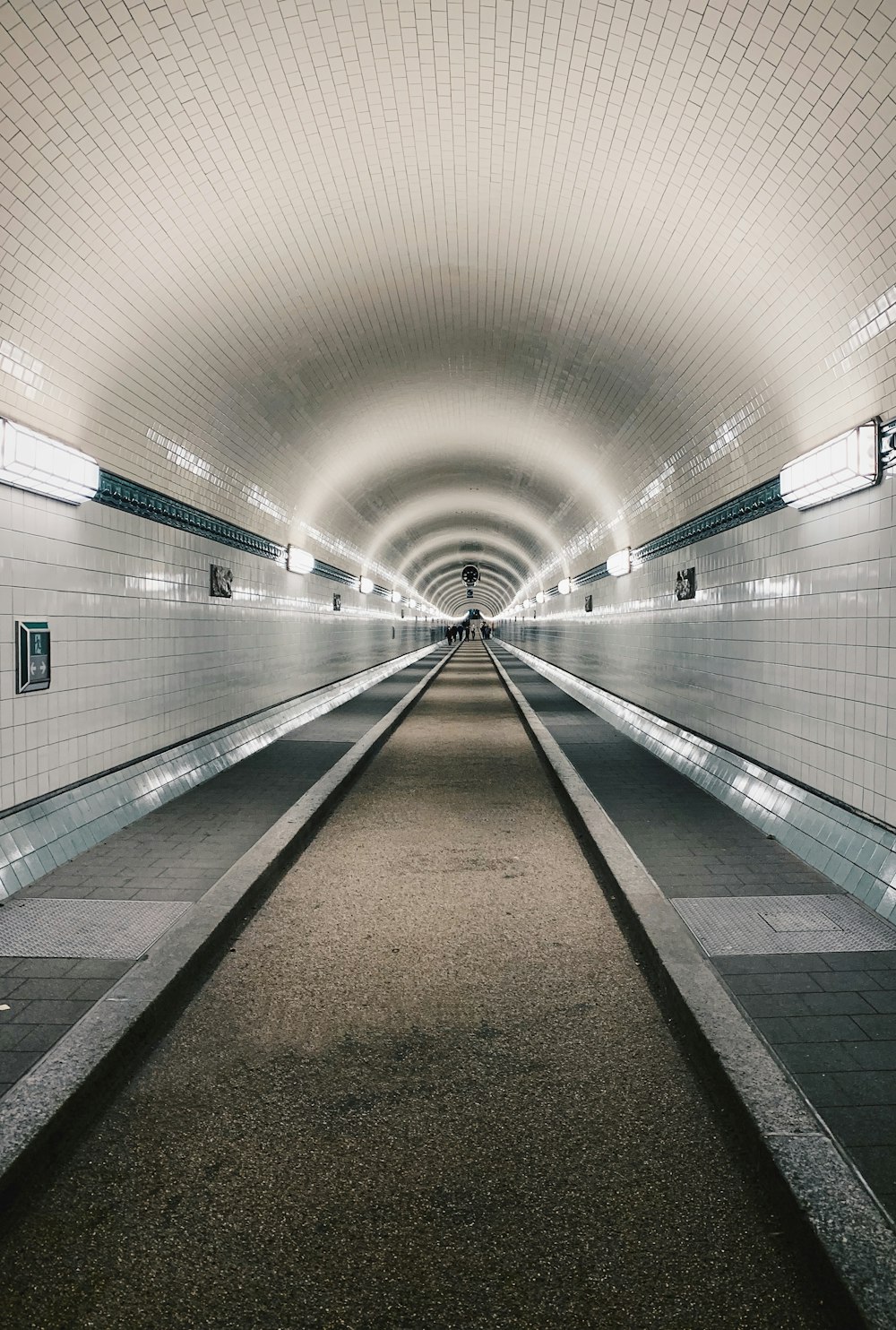 brown and white hallway with lights turned on in the middle