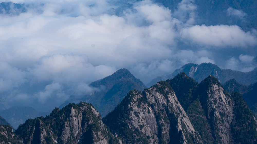 gray and black mountain under white clouds during daytime