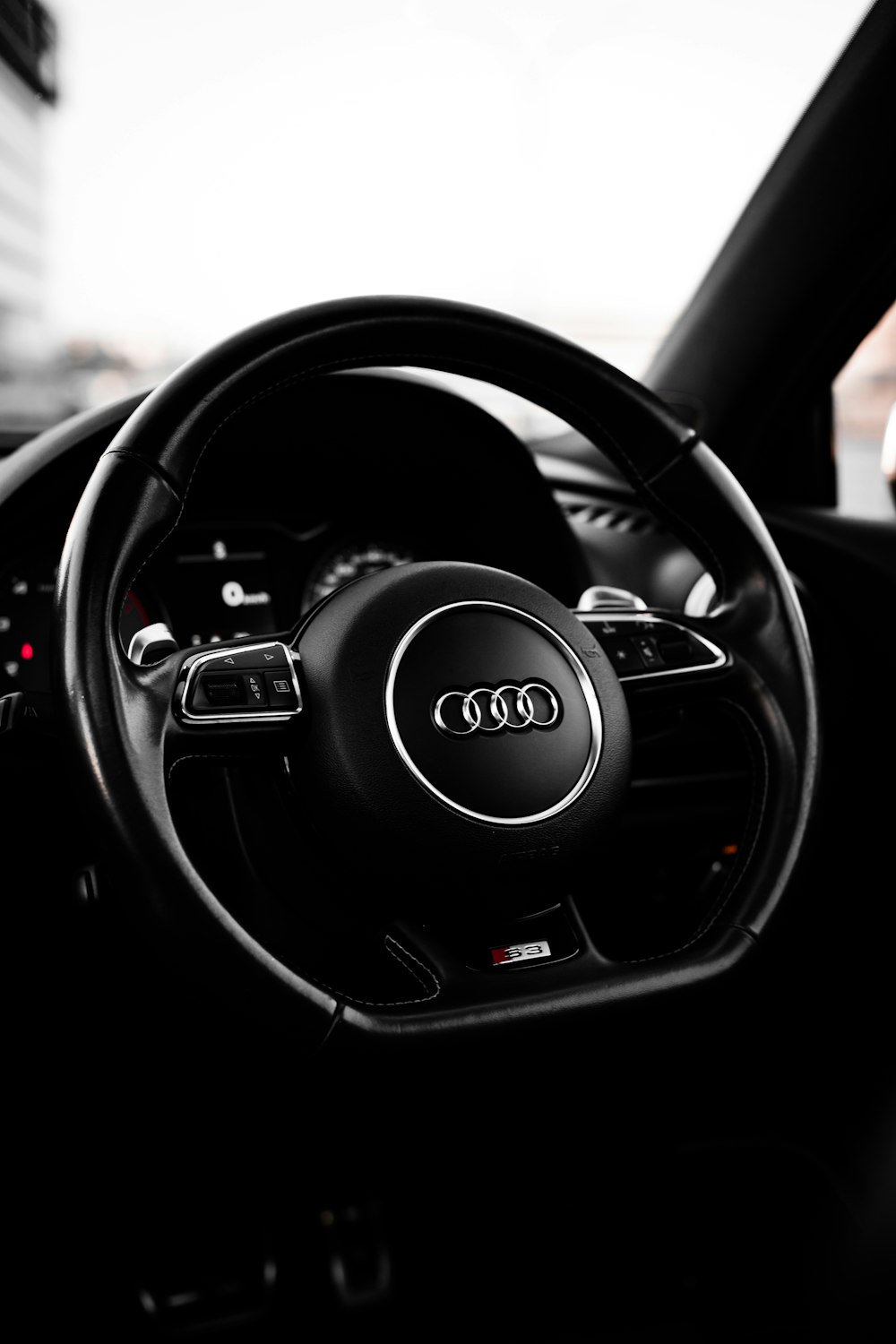 black audi steering wheel in close up photography