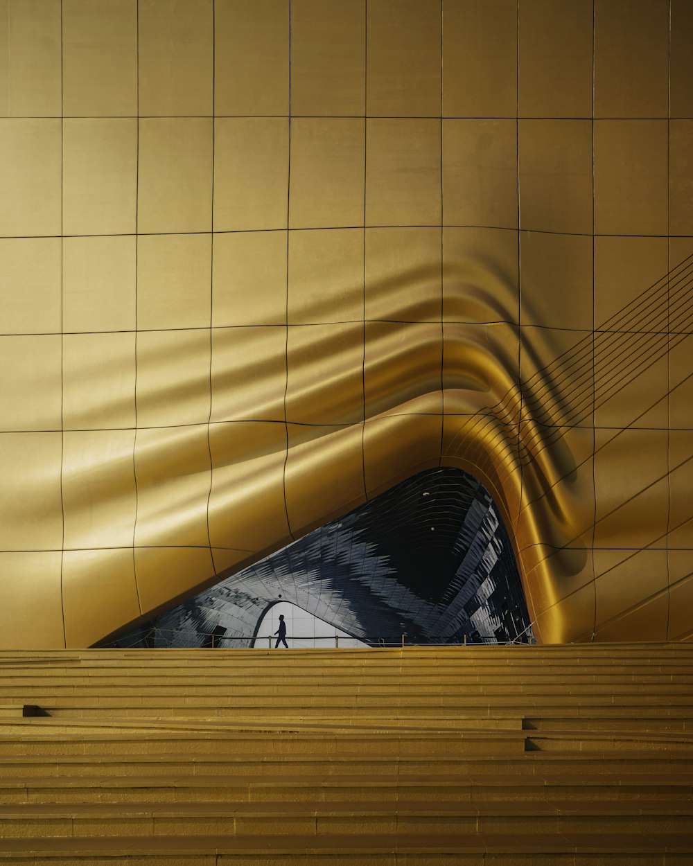 person in black and white shirt lying on yellow bed