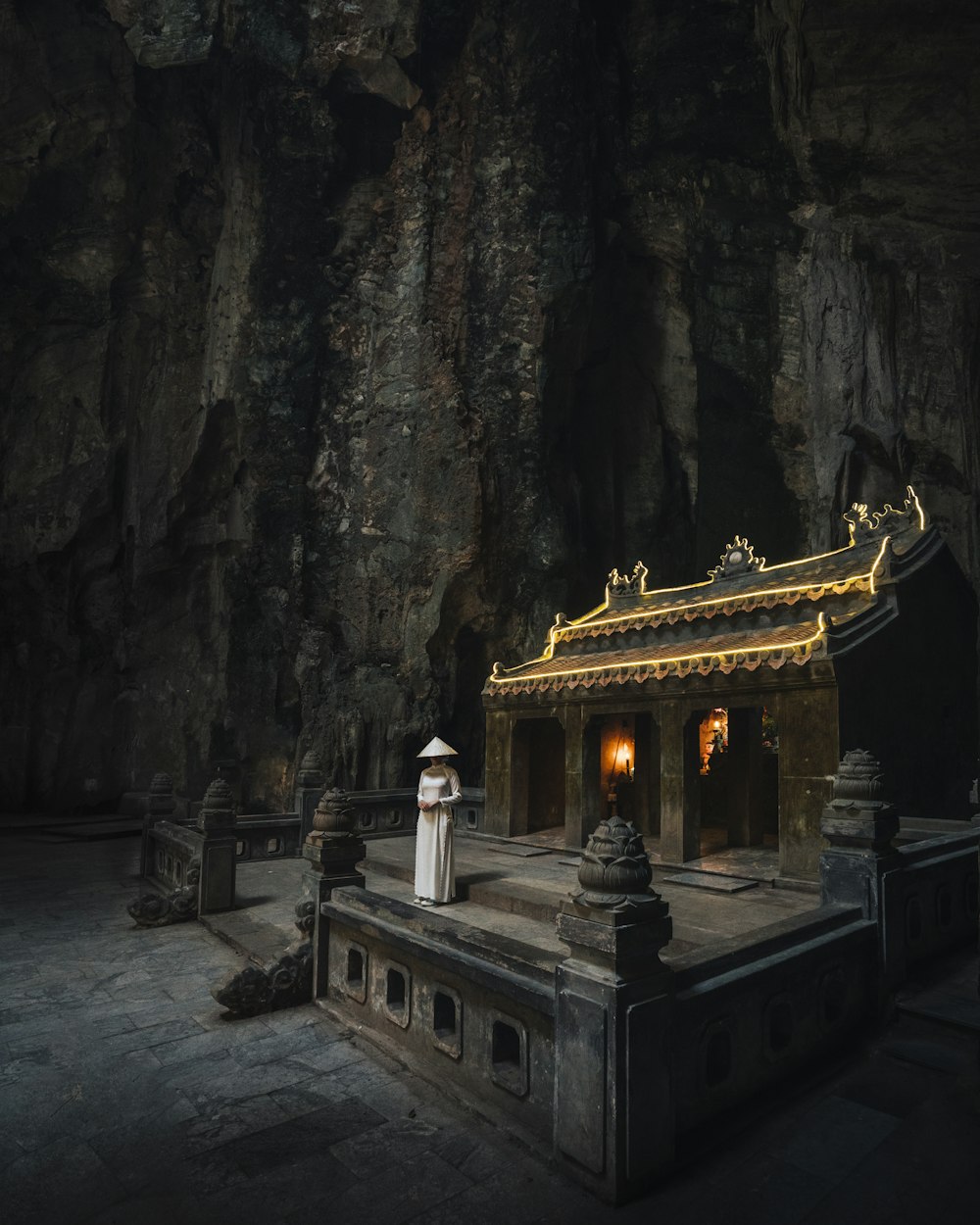white and gold temple on gray rock formation