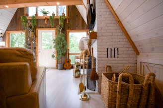 brown wooden acoustic guitar near brown wicker armchair