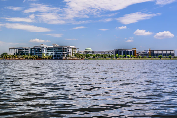 A modern Florida community with sleek buildings and lush landscaping under a clear blue sky.