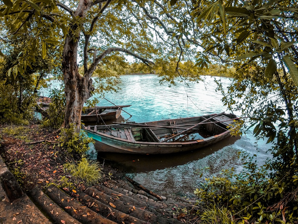 brown wooden boat on river during daytime