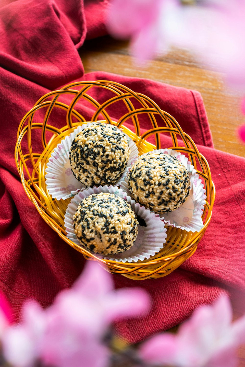 three round white and brown cookies in brown woven basket