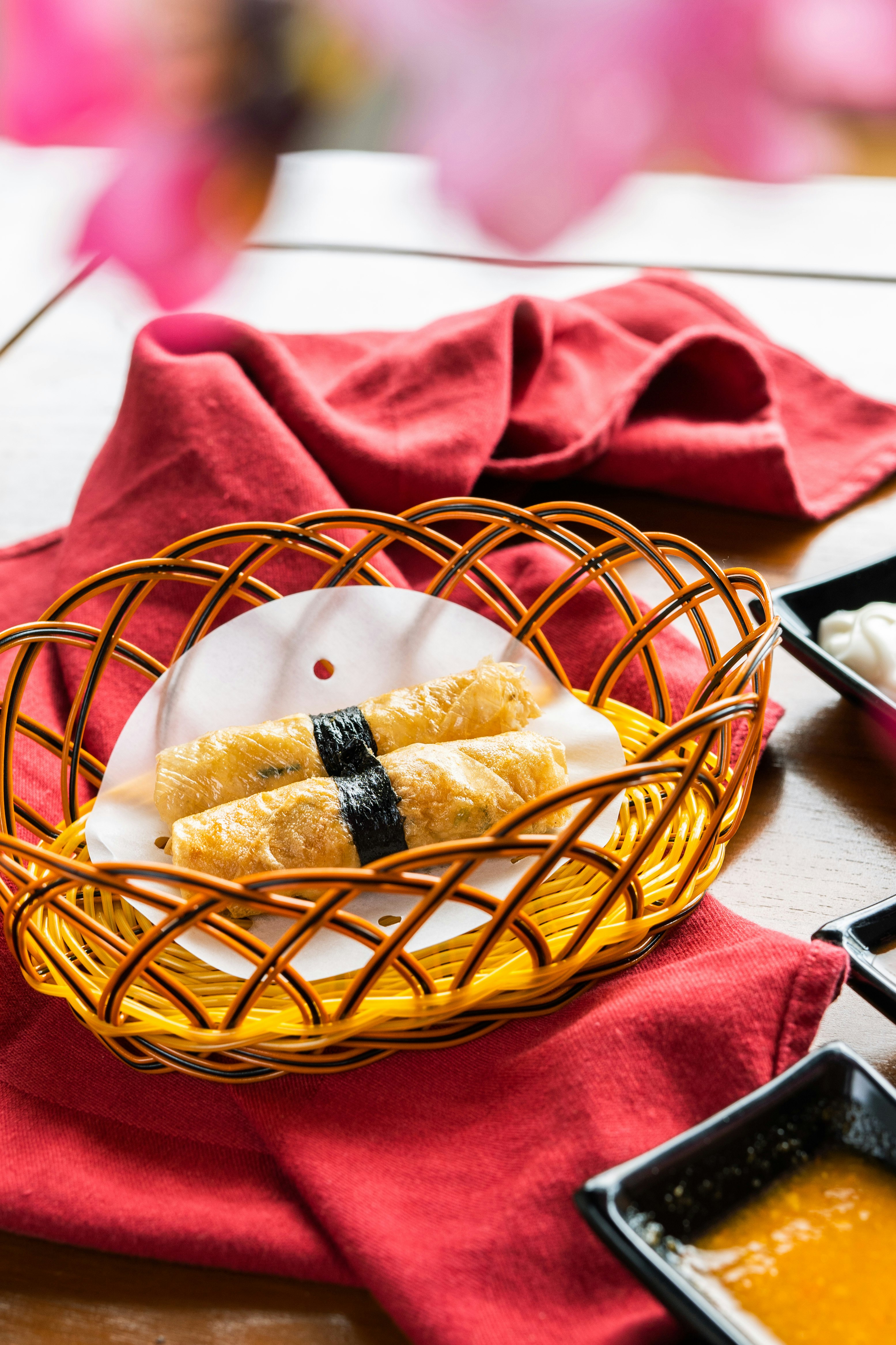 brown woven basket on red textile