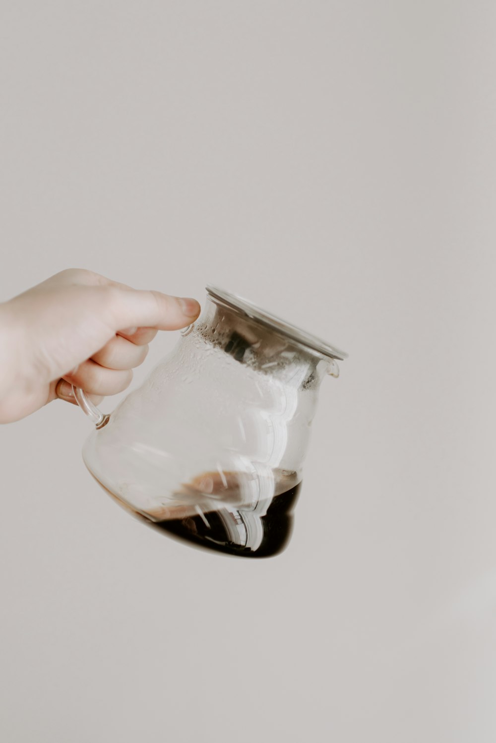 person holding clear glass jar