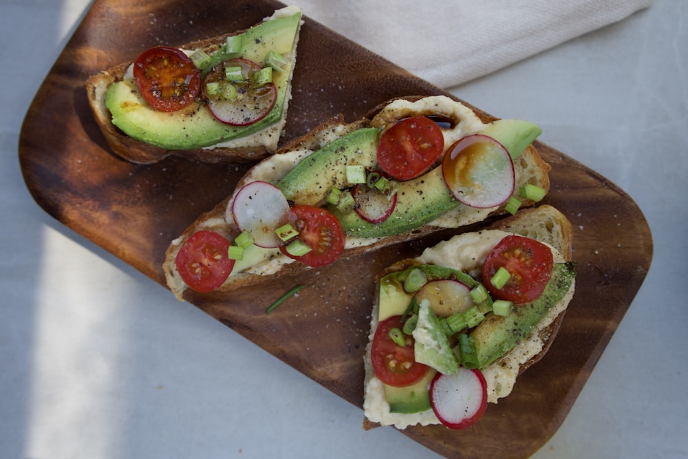 sliced cucumber and tomato on brown wooden chopping board